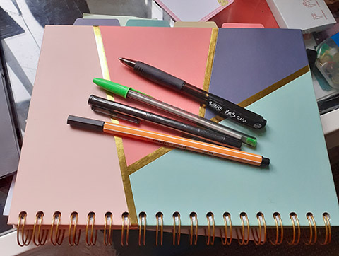 Pens sitting on a notebook