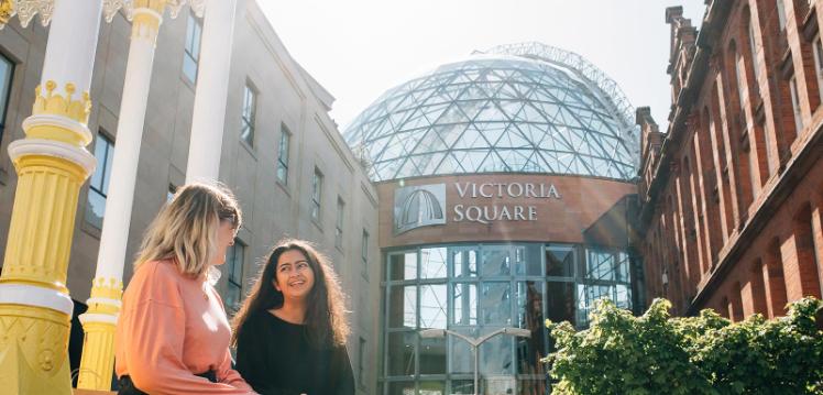 Two students in front of Victoria Square