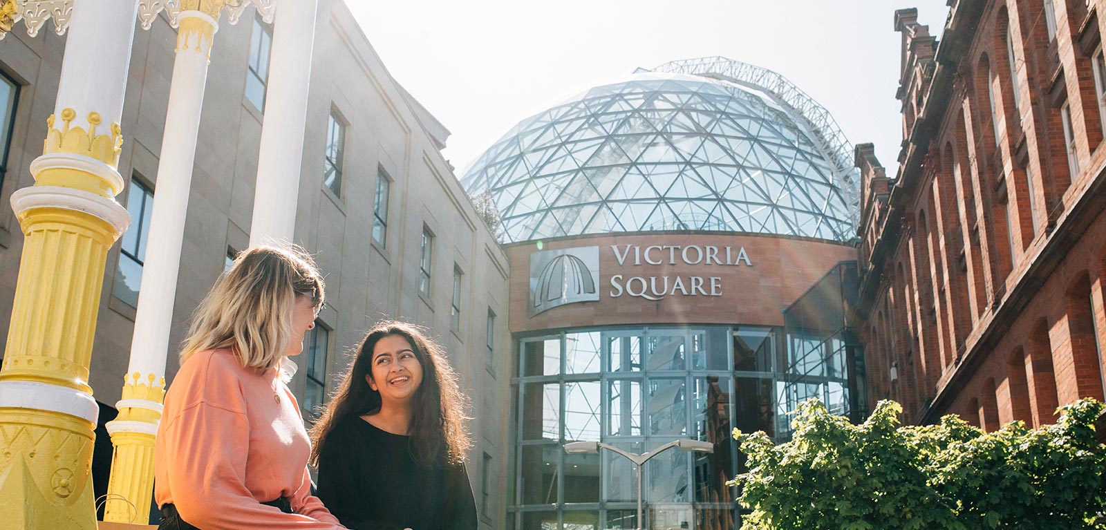 Two students in front of Victoria Square