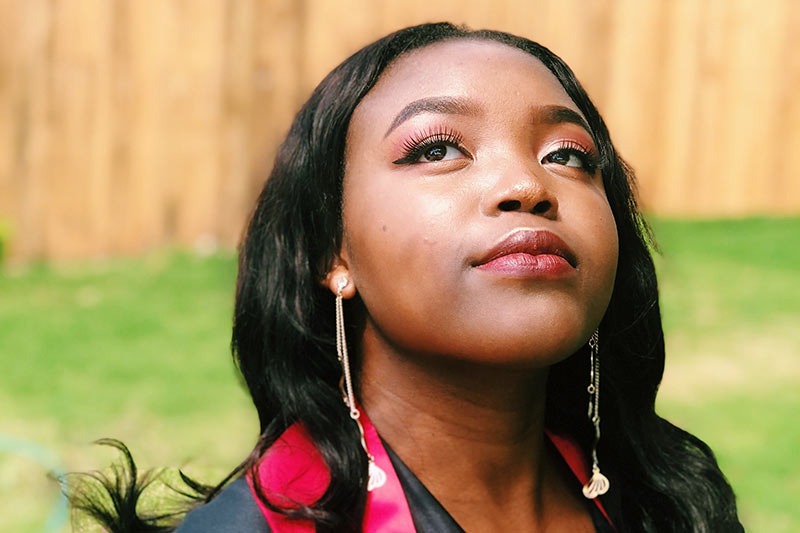 Female graduate looking up thoughtfully