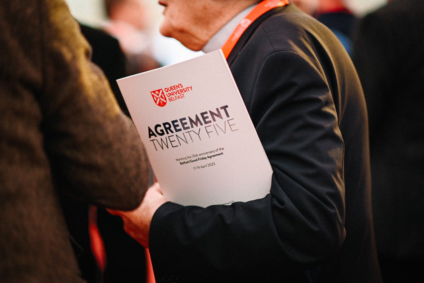 An attendee carries the conference programme