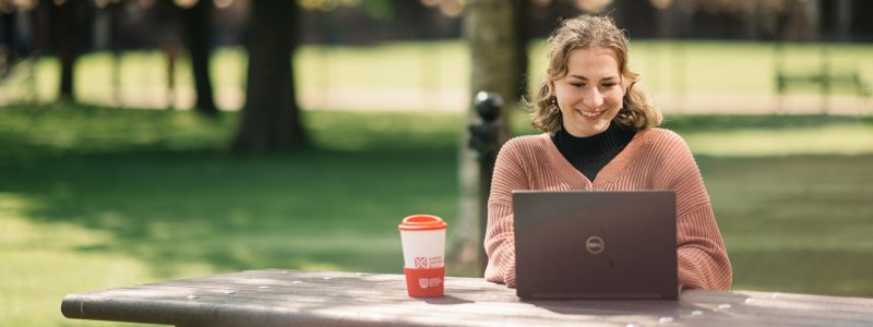 Student on a laptop in the quad