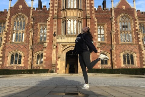 Student standing in front of Lanyon