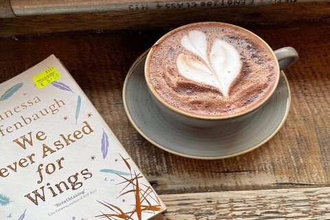 Book and a cup of coffee on a table