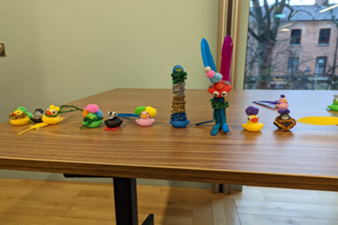 Row of rubber ducks on wooden table