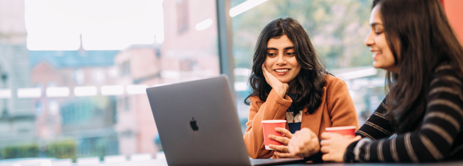 Two students looking at a laptop