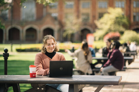 Student sitting outside campus