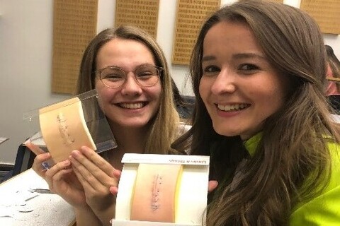 Two Medicine students completing suturing workshop