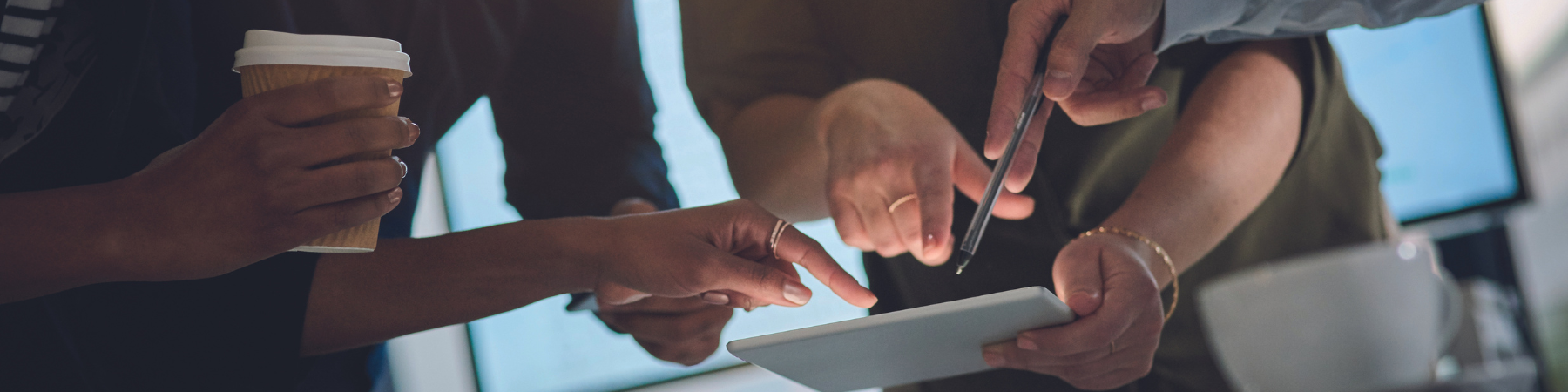 People's hands above a laptop