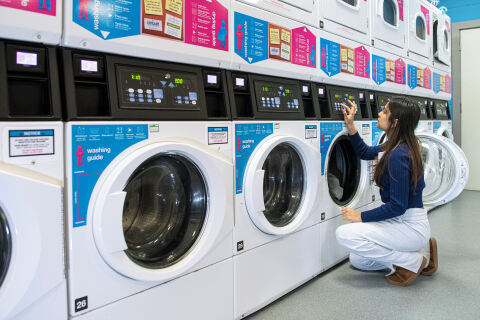 Student doing laundry at the Treehouse, BT9