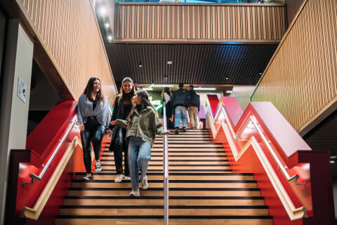 Students walking downstairs in One Elmwood