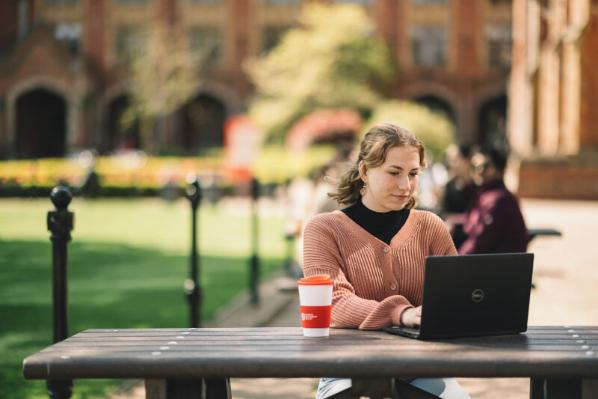 Student on laptop in the Quad