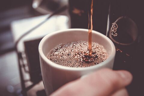 Machine dispensing coffee in mug