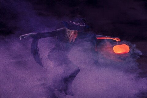 Witch holding a pumpkin lantern