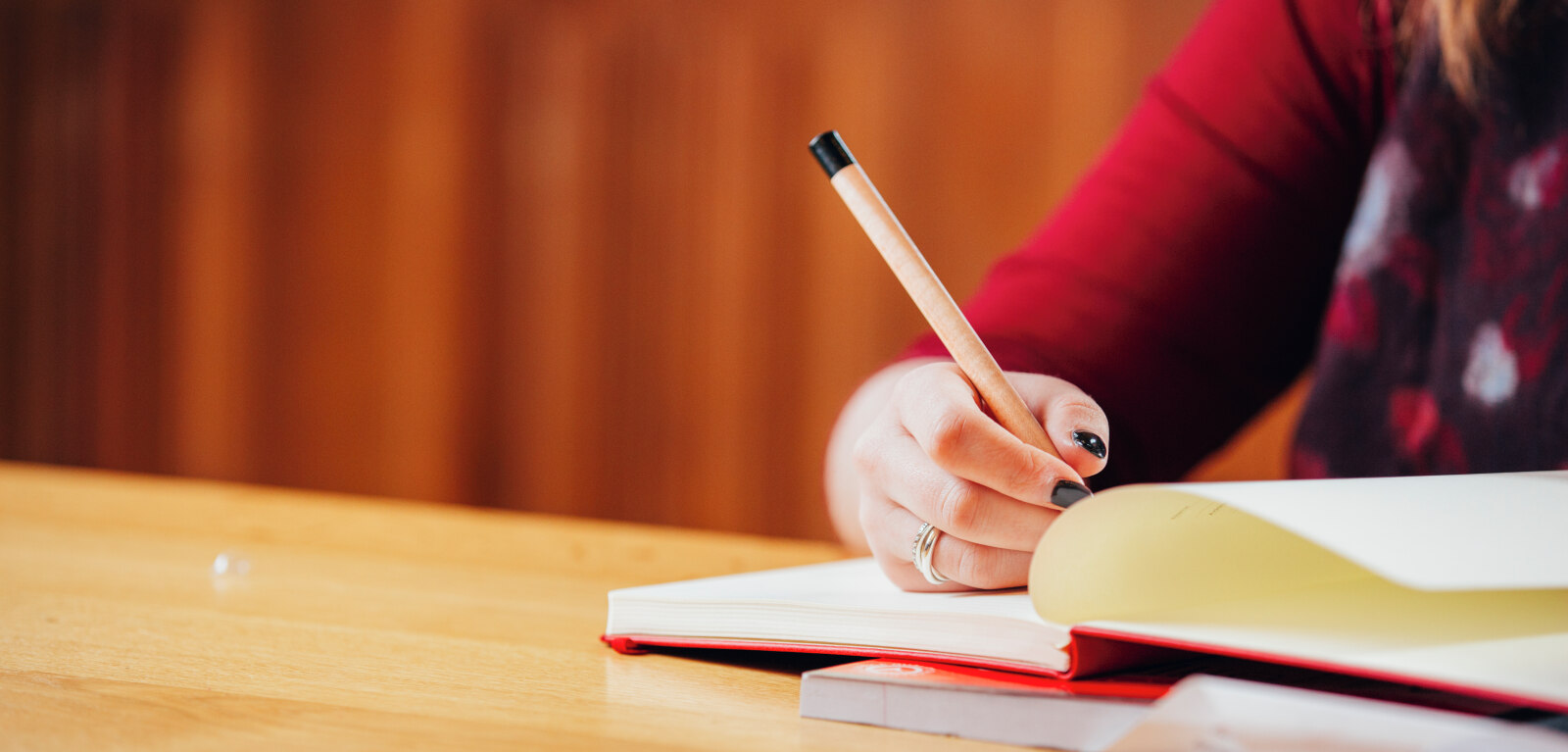 Student writing in notebook