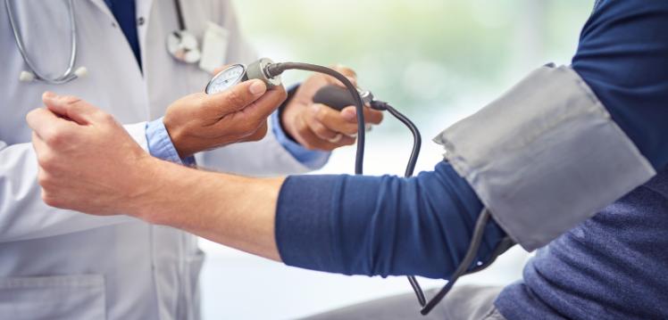 Doctor taking blood pressure of a patient