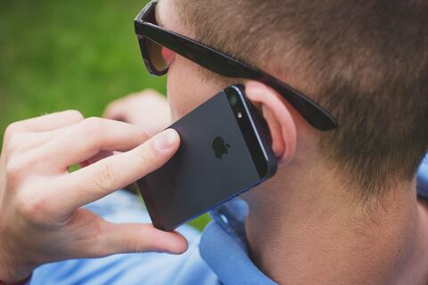 Person making a phonecall with apple iphone