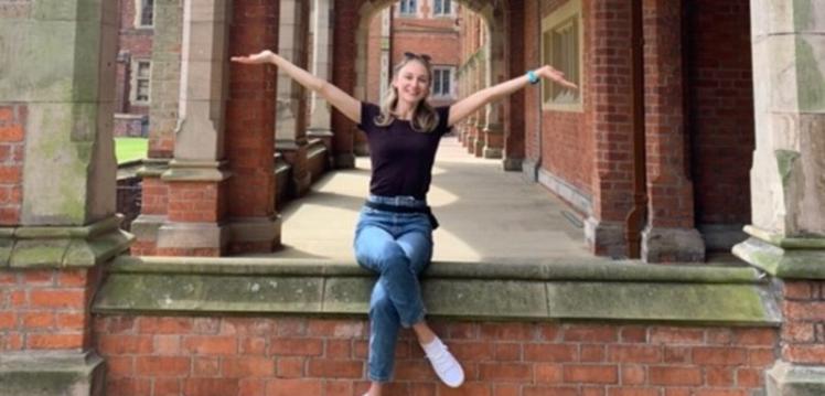 Student posing in the Quad