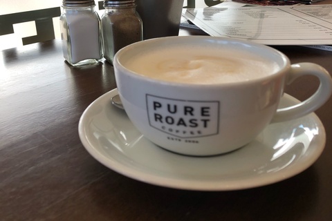 Cup of coffee and saucer on table in cafe