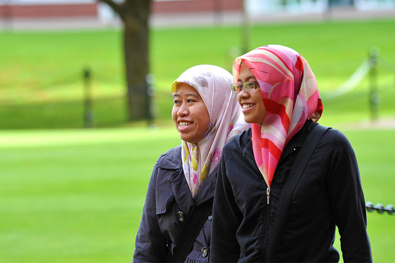 two international female students walking around the Quad