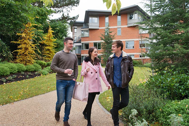 3 students walking away from accommodation at Elms Village