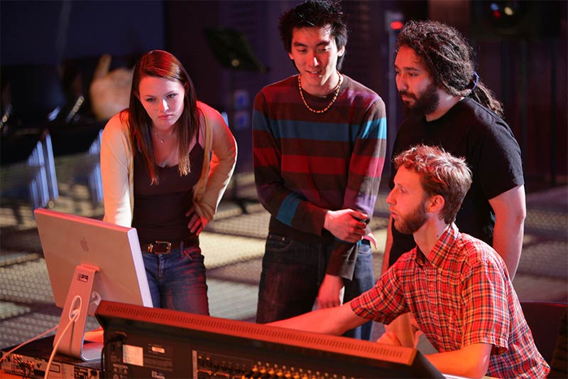 group of students using the music facilties together