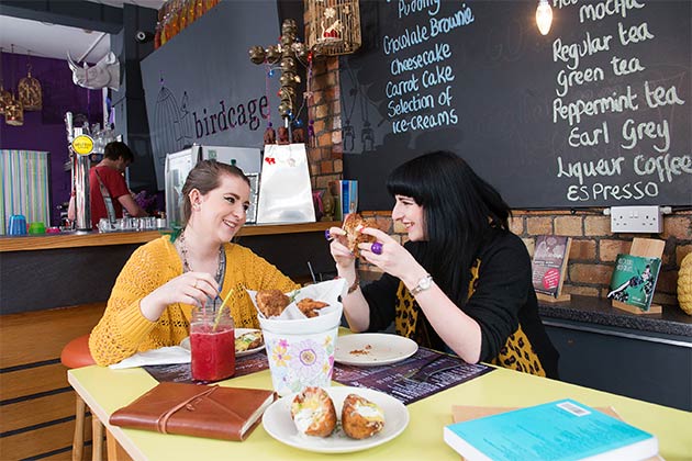 two female students enjoying lunch together in a casual restaurant