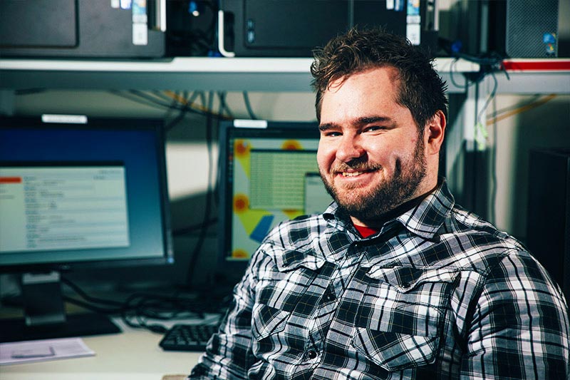 Male postgraduate student in front of computer