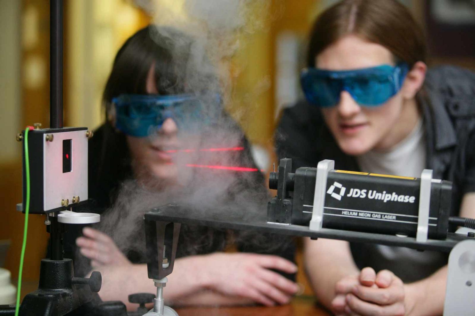 Students in a Lab experimenting with a Laser