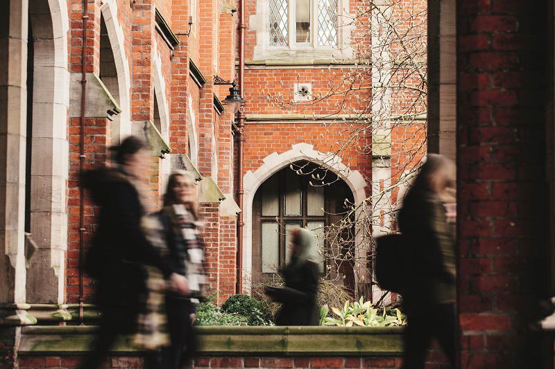 Blurred students walking through the quadrangle of the Lanyon Building