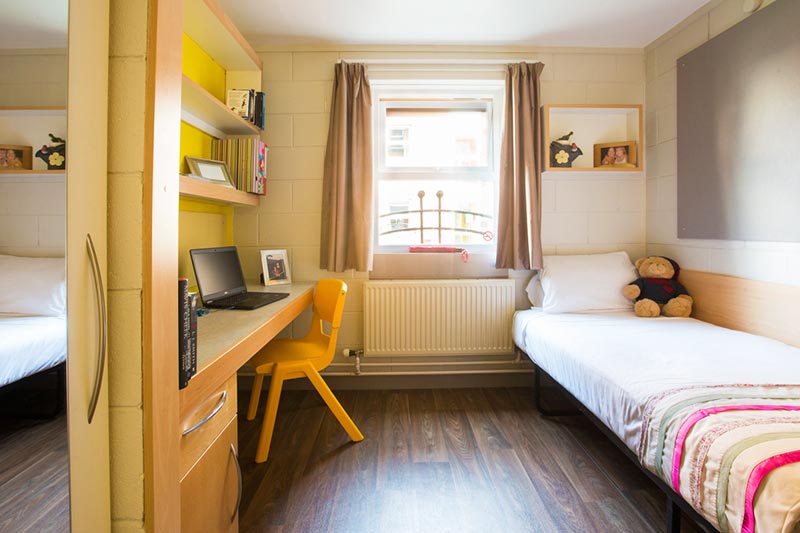 Room in Elm's Village with yellow chair