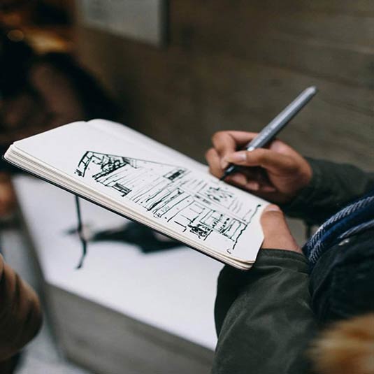 an architecture student sketching a building