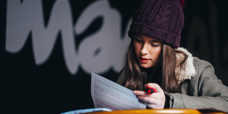 female student highlighting lecture notes