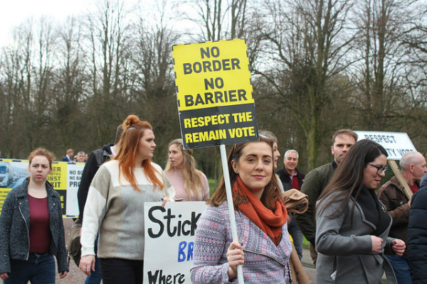 Protestors wielding placards against a hard border in Ireland 