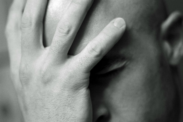 Man holding his face in his hands