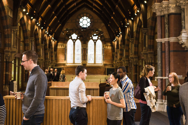 crowd drinking coffee and talking at the graduate school