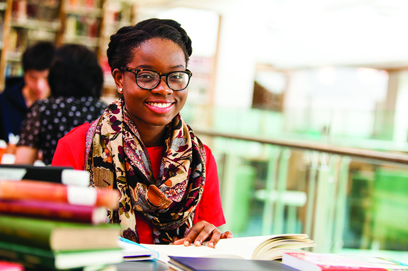 smiling student with books