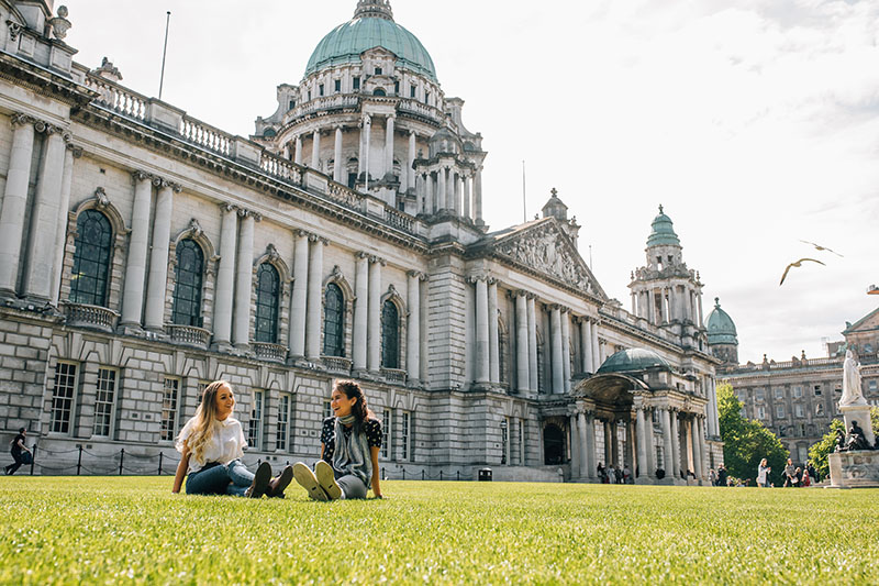 Students seated on the grass outside City Hall