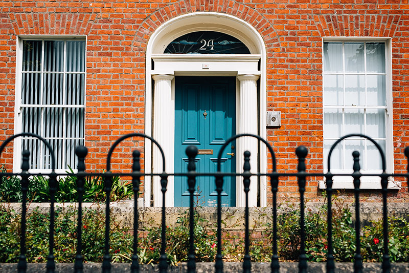 Blue door through railings university street