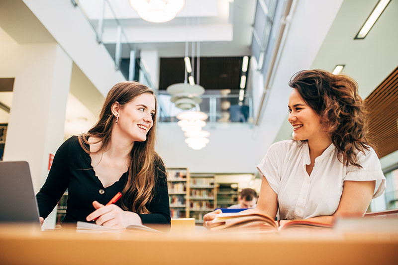 Students smiling in library