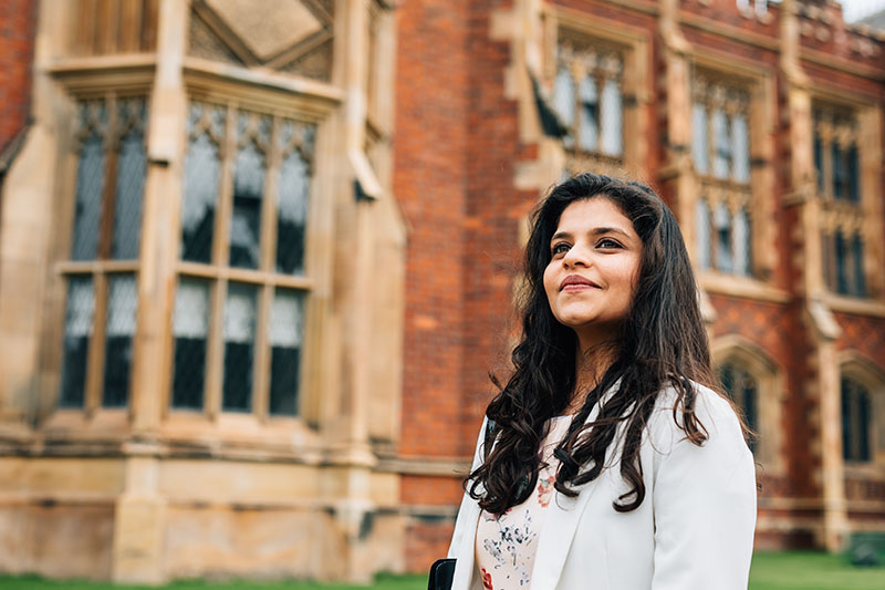 Student looking upwards outside Lanyon