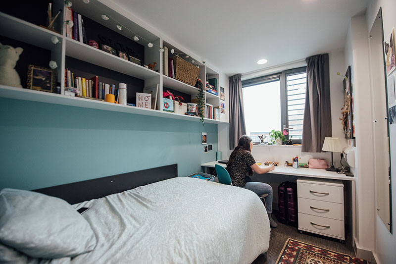 Female student at desk in bedroom