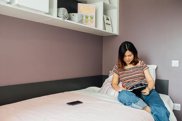 student reading on bed