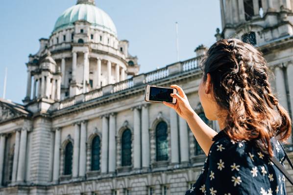 Student taking a picture of City Hall