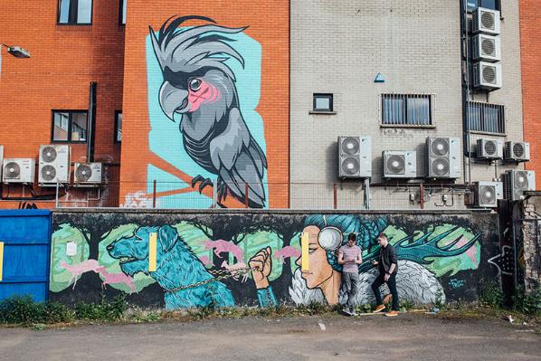 Students by graffitti walls