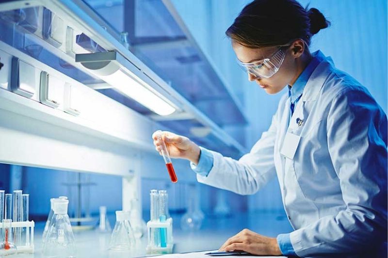 Pharmacy student with test tubes