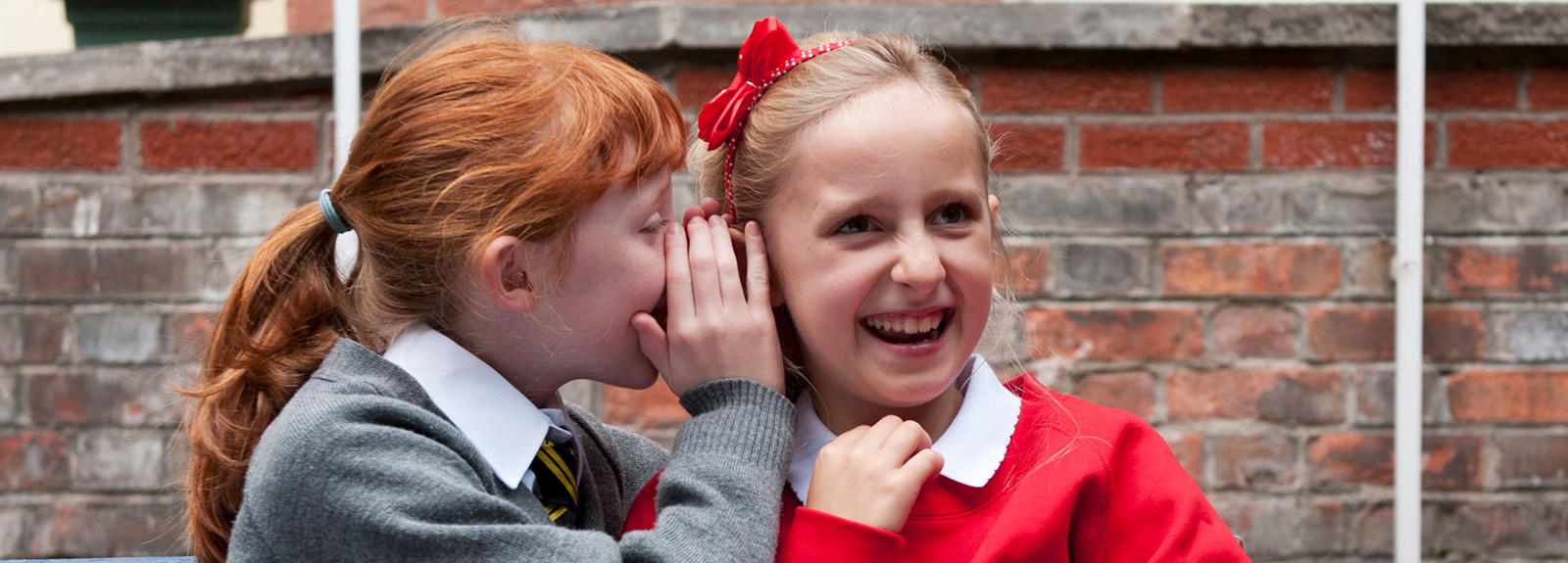 two girls whispering