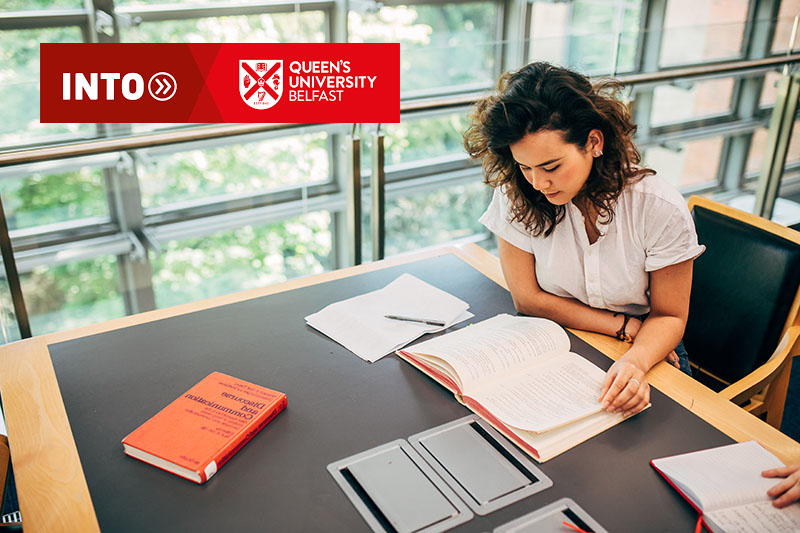 A female student reading in the library