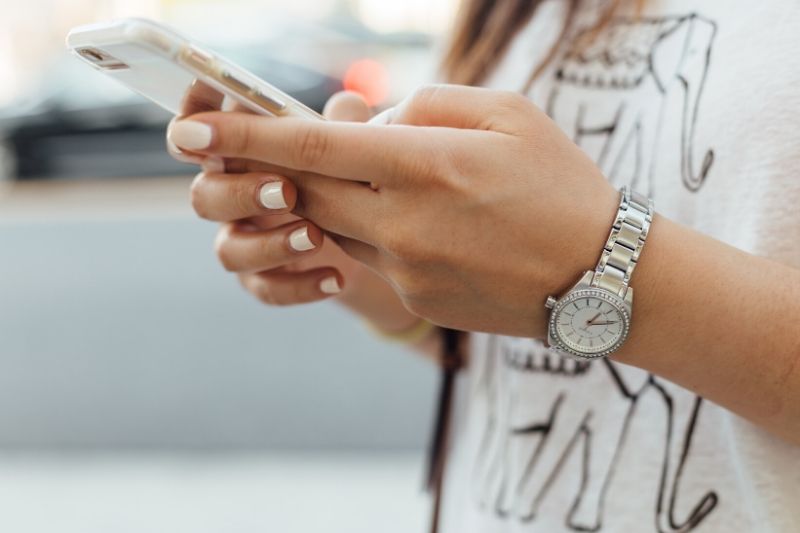 A woman's hands on a mobile phone
