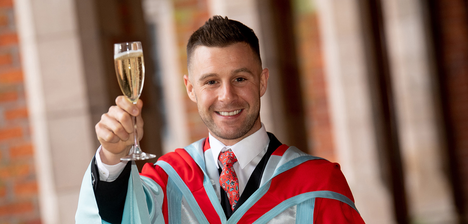 Jonathan Rea holding a glass of bubbly 